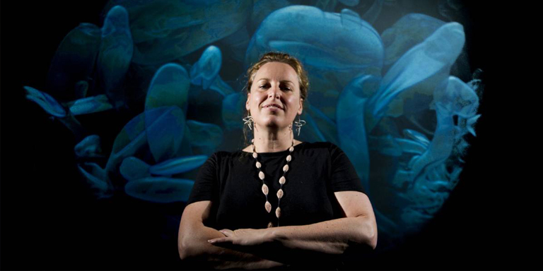 Erica Seccombe in front of Out of Season, stereoscopic projection installation. Photograph Jay Cronan, Canberra Times, 2015